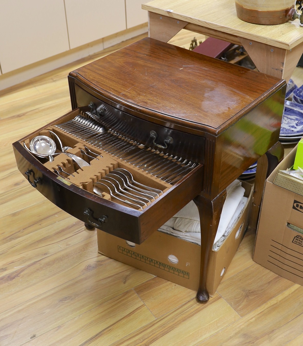 A suite of cutlery, in mahogany two drawer cabinet